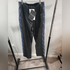Black leather pants trimmed with blue floral embroidery,  size 10
